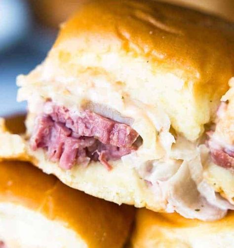 Easy to make slow cooker corned beef is layered on these sliders. Topped with Swiss cheese and a homemade Russian Dressing that makes these the BEST tasting Reuben Sliders around!! Food Shooters, Hawaiin Appetizers, Homemade Russian Dressing, Reuben Sliders, House Of Yumm, Tailgate Treats, Diy Party Food, Slow Cooker Corned Beef, Cheese Sliders