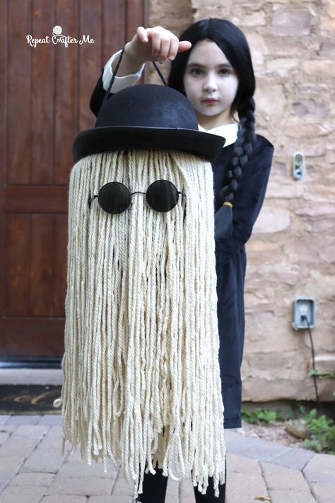 Happy October! One of my favorite months because our family loves Halloween! This year we decided that for our family costume we would be the Addams Family! Zoe absolutely nailed the part of Wednesday Addams and my middle guy Chase is a dead ringer for Pugsley! I think I play a pretty awesome Morticia. My … Original Wednesday Addams, Cousin It Dog Costume, Adams Family Halloween Party, Addams Family Classroom Door, Adam’s Family Family Costume, Cousin It Halloween Bucket, Mortician Addams Costume Diy, Wednesday Addams Wreath, Wednesday Adams Pumpkin