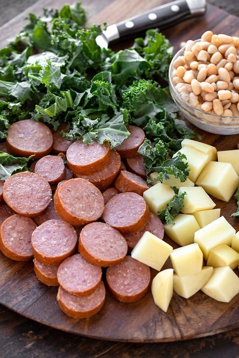 Smoked sausage, potatoes, kale and white beans are the star ingredients in this rich and hearty sausage soup! | thecozyapron.com #sausagesoup #sausagesouprecipes #sausagesouphealthy Potato And Smoked Sausage Soup, Yellowstone Recipes, Sausage Soup Healthy, Sausage Kale Soup, Beans Recipe Crockpot, Bean And Sausage Soup, Chicken Sausage Pasta, Sausage And Kale Soup, Beans In Crockpot