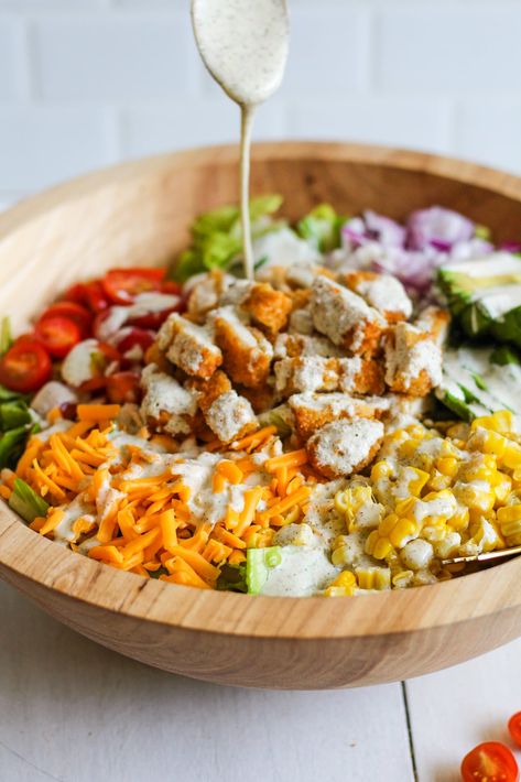 Prepare to make your newest favourite salad! This Crispy Chicken Salad is filled with crunchy romaine, juicy cherry tomatoes, creamy avocado, fresh red onion, and crisp corn. It is then topped with crispy chicken tenders, cheddar cheese, and a creamy and zesty homemade Greek yogurt ranch dressing. It makes a tasty, healthy lunch or dinner […] Chicken Nuggets Salad, Salad With Chicken Tenders, Sticky Chicken Salad, Chicken Tender Salad Recipes, Crispy Chicken Bowl, Chicken Nugget Salad, Crispy Chicken Salad Recipe, Crunchy Chicken Salad, Fried Chicken Salad