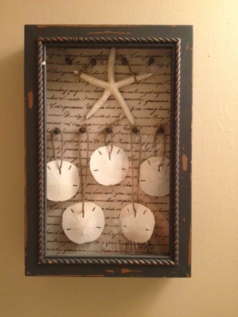 When Gerry and I got married two years ago we used sand dollars as our seating cards…I loved how they turned out but I originally planned to use one sand dollar per person. We ended up using … Sand Dollar Shadow Box Ideas, Sand Dollar Crafts Ideas, Sand Dollar Display, Beach Shadow Boxes, Sand Dollar Craft, Sand Dollar Art, Shadow Box Ideas, Beach Themed Crafts, Seashell Projects