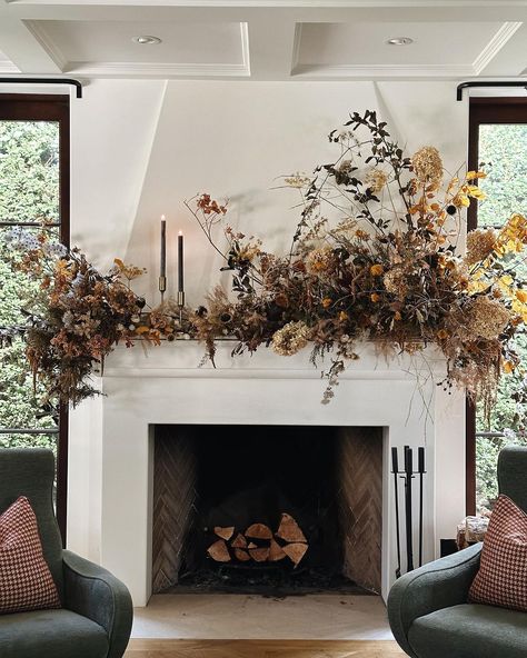 We manufactured a mantle extension to pull this off. Someday I’ll share the time lapse. For now, please enjoy the fall-infused explosion… | Instagram Flowers Fireplace, Mantel Greenery, Real Wood Burning Fireplace, Fall Mantel Decorating Ideas, Mantel Decorating Ideas, Fall Mantle Decor, Mantel Decorating, Rustic Fall Decor, Seasonal Displays