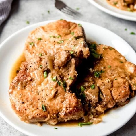 This easy Smothered Pork Chops Recipe is a Southern classic and true soul food that always satisfies.  The velvety, savory gravy and tender, juicy pork chops go so well together and are as perfect for weeknight cooking as they are for Sunday supper. Pork Chops In Gravy, Southern Smothered Pork Chops, Pork Chops Recipes, Smothered Pork Chops Recipe, Slow Cooked Pulled Pork, Pork Chops And Gravy, Chicken Shawarma Recipe, Smothered Pork, Shawarma Recipe