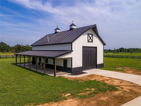 10409 Osage Ridge Ln, Bentonville, AR 72713 | MLS #1153903 | Zillow Pole Barn Landscaping Ideas, Black And White Pole Barn, Farm Shop Buildings, White Pole Barn, Barn Pool House, Rv Shop, Barn Colors, Pole Barn Ideas, Barn Pool