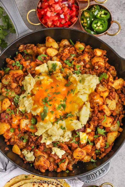 Start the day off right with this chorizo hash recipe. Spicy or sweet chorizo sausage is fried with bacon and then cooked with smooth and silky Yukon Gold Potatoes. Topped with eggs and cheese and then baked in the oven, this chorizo hash is so cheesy and filling. Make it a complete breakfast with a cup of coffee or tea!  #chorizohash #chorizobreakfast #beakfastchorizohash #spendwithpennies Papas And Chorizo, Chirozo Breakfast Recipes, Mexican Breakfast For A Crowd, Best Mexican Breakfast Recipes, Chorizo And Beans, Beef Chorizo Recipes Dinners, Chorizo Dinner Ideas, Spanish Sausage Recipes, Breakfast Nachos Scrambled Eggs