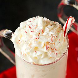 Spiked White Hot Chocolate with Crushed Candy Canes | Brown Eyed Baker Peppermint White Russian Recipe, Homemade Peppermint Mocha, White Hot Chocolate Recipe, White Russian Recipes, Brown Eyed Baker, Peppermint White, White Hot Chocolate, Cocktail Desserts, Flavored Vodka