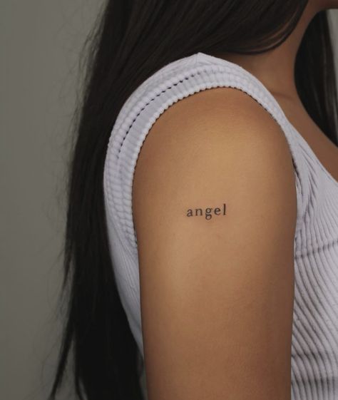 My Angel Tattoo Words, Angel Words Tattoo, Angle Word Tattoos, Angel Tattoo Letters, Angel Written Tattoo, Angel Tatoos Aesthetic, Minimalistic Angel Tattoo, Simple Tattoo Lettering, Angel Tattoo Shoulder