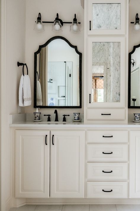 We love how this traditional master bathroom remodel turned out! The classic white cabinets paired with the black hardware and mirrors marries timeless elegance with modern charm. Master Bath White Cabinets, Bathroom Vanity Traditional, Bathroom Vanity With Storage, Traditional Master Bath, Bathroom Cream, Vanity With Storage, Traditional Design Style, Blue And White Chinoiserie, Transitional Bathroom