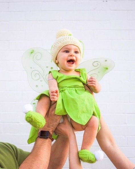 parents holding up a baby 16 Month Old Halloween Costume Girl, 3 Month Old Halloween Costume Baby Girl, 10 Month Old Halloween Costume, Baby’s First Halloween Costume, 3 Month Old Halloween Costume, Baby Girl First Halloween Costume, Girls Tinkerbell Costume, Disney Halloween Costumes Diy, Tinkerbell Halloween Costume