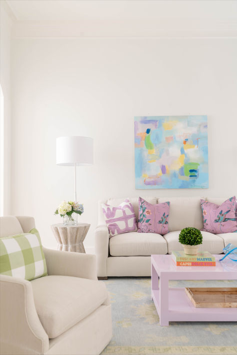 A small hint of color can help structure the space. We designed this family room with a custom coffee table to anchor down the color pallet. As soon as you walk in the first thing you see is lavender but softens when you look around. Living Room Pastel Colors Inspiration, Small Living Room Coffee Table, Living Room Designs Preppy, Pink And Blue Coastal Living Room, Pop Of Color Room, Pops Of Color Living Room, Grand Millenial Coffee Table, Dorm Living Room Ideas, Apartment Living Room Preppy