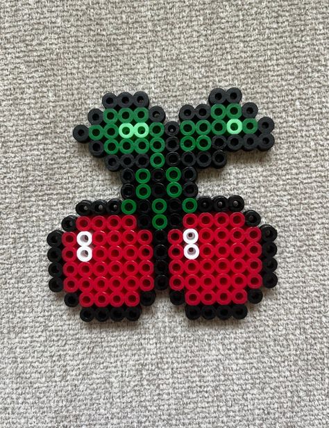 Cherry perler bead magnet made with red, green, black and white beads. Melted Bead Patterns, Fruit Perler Bead Patterns, Perler Beads Small Cute, Teacher Perler Bead Patterns, Lava Lamp Perler Beads, Small Square Perler Bead Patterns, Small Fuse Bead Ideas, Pearl Beads Ideas, Cute Perler Bead Patterns