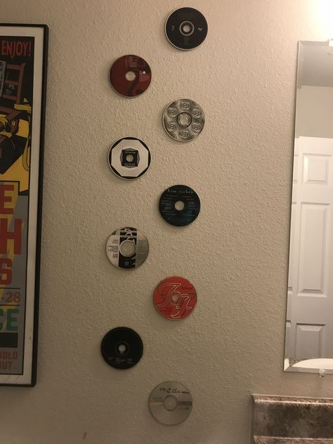 Step 4, find old cds and use the same tape ( double sided and paint safe) and hang to your delight. Hanging Cds, Cds Hanging From Ceiling, Old Cds Aesthetic, Music Discs On Wall Aesthetic, Cds 2000s Aesthetic, Old Cds, Old Cd, Music Themed, Record Store