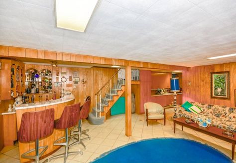 Wood paneling and a classic 1960s floral sofa in the basement rec room. [From ELLEDecor.com] Related:The Most Popular Rooms Of The WeekWhy THIS House Sold For 70% More Than Its Asking PriceWhy A Partially-Painted Room Could Be Best Via HGTV.ca  - Redbook.com Retro Basement, Basement Wet Bar, Floral Sofa, Basement Bar Designs, 1950s House, Interior Vintage, Retro Room, St Albans, Retro Interior