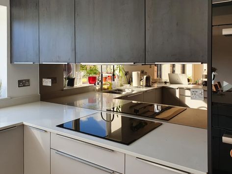 Bronze mirror shown here installed by Southern Counties Glass in a modern kitchen. Bronzed Mirror Splashback, Kitchen Mirrored Backsplash, Tinted Mirror Backsplash, Kitchen Mirror Splashback Ideas, Smokey Mirror Splashback, Bronze Mirror Splashback Kitchen, Backsplash Mirror Kitchen, Mirror Behind Kitchen Sink, Bronze Splashback Kitchen