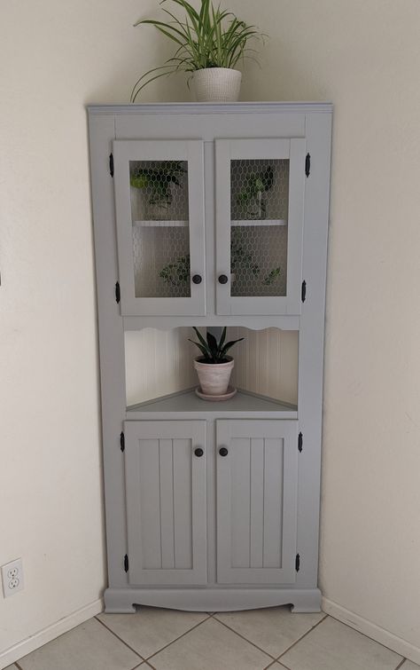 Paint Corner Cabinet, Farmhouse Corner Cabinet Living Room, Farmhouse Corner Cabinet Bathroom, Corner Cabinet Repurpose, Tall Corner Cabinet Ideas, Corner Cabinet Ideas Bathroom, Corner Cabinet Ideas Living Room Decor, Styling A Corner Cabinet, Corner Cabinet Paint Ideas