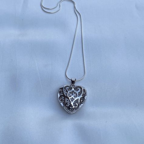 Both sides of this heart pendant are beautiful and will add versatility to your accessories. It comes on a sterling silver snake chain with a delightful silky feel. Wear it by itself or stack it with other necklaces. Necklace- Length: 16 or 20 inches- Width: 0.7mm- Clasp: spring clasp- Metal: 925 sterling silver- Finish: high polishPendant- Size: 23x22x9mm, Hole: 3mm- Material: Brass and Cubic Zirconia- Metal Color: Platinum Orders ship within two days Monday to Saturday Gift Heart Pendant Jewelry With Box Chain, Silver Heart Pendant Locket Charm Necklace, Silver Charm Necklace With Heart Pendant Locket, Silver Heart Pendant Charm Necklace As Keepsake, Silver Heart Pendant Charm Necklace For Keepsake, Silver Open Heart Charm Necklace For Keepsake, Silver Open Heart Keepsake Charm Necklace, Heart Pendant Necklace With Silver Chain For Gift, Silver Chain Heart Pendant Necklace