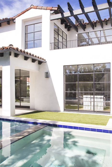 white facade, spanish tile, black windows, wood slats pergola, simple black railing for the top decks Modern Spanish House Exterior, Spanish Transitional, Spanish House Exterior, Modern Spanish Home, White Facade, Spanish Beauty, Black Railing, Modern Hacienda, Mission Style Homes