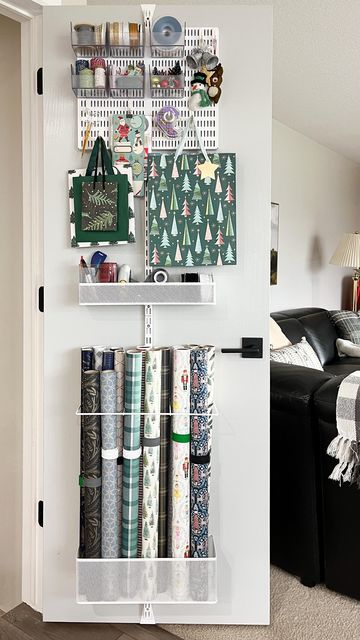 The Container Store on Instagram: "Get ahead of the holiday clutter with an Elfa solution! ❤ #TheContainerStoreAmbassador @smallstuffemily used the Elfa Gift Wrap Over The Door Rack to keep wrapping essentials hidden, yet easily accessible. #TheContainerStore #giftwrap #giftwrapping #giftwrapped #giftwrappingideas #holidaygifts #holidayideas #holidayinspo #closetorganization #closetmakeover #diyproject #storageideas #organizingideas #getorganized #organizedliving" Wrapping Paper Door Storage, Container Store Gift Wrap Organizer, Organize Wrapping Supplies, Gift Wrap Storage Ideas Small Spaces, Gift Organization Ideas, Picture Frame Storage Ideas, Gift Storage Ideas, Back Of The Door Storage Ideas, Organize Wrapping Paper And Gift Bags