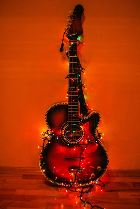 acoustic guitar surrounded with string lights against the wall #Guitar #Lights #Color #Colour Red, Blue #red #blue #yellow #dark #romance #music #abstract #background #standing new year #holidays #holiday #woman #bulgarian #kremona #old musical Instrument arts And Entertainment #musician wood - Material rock Music #sound musical Instrument String colored background studio shot arts culture and entertainment #4K #wallpaper #hdwallpaper #desktop Gutair Wallpaper, Christmas Guitar, Black Acoustic Guitar, Peace Love Music, Pretty Guitars, Micro Photography, Black Electric Guitar, Instruments Art, Guitar Photos