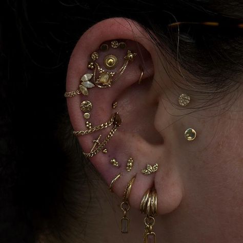 I’ve lost track of what all I’ve done on Taylor’s ear at this point, but last week we added a lower flat with a rose gold and rutilated… | Instagram Gold Earscapes, Maximalist Ear Piercings, Industrial Piercing Aesthetic, Ear Setup, Unique Piercing, Ear Styling, Constellation Piercings, Piercing Inspo, Ear Art