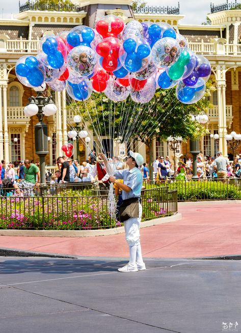 https://flic.kr/p/2ap9NFX | The Balloon Seller | Probably one of the most iconic cast members at the Magic Kingdom is the balloon seller. You can see these old time dressed people up and down Main Street selling all kinds of balloons from character to light up. Do you often buy a balloon from the balloon seller? Have a magical day!  Visit Disney Photo Tour on Facebook and Instagram Disney Budget, Balloon Seller, Disney Balloons, Disney Parade, Disney On A Budget, Have A Magical Day, Disney Princess Fan Art, Budget Tips, Card Tricks