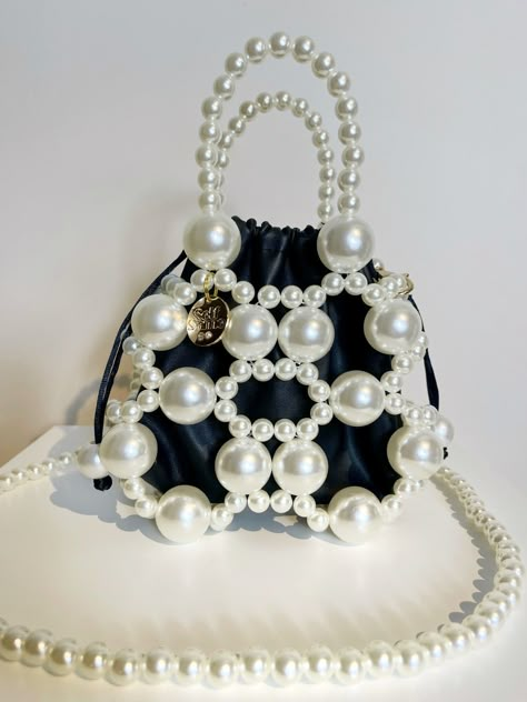 Introducing the Esti Pearl Handbag - a true work of art. This exquisite evening bag features a delicately handcrafted inner pouch, nestled within a mix of lustrous faux pearls. The vegan leather inner pouch features a drawstring closure to keep your party essentials secure. Esti also comes with a detachable pearl strap which is ideal for cross body wear. Finished off with Self-Same's embellished logo charm. Measurements Height 24cm Width 18cm Depth 10cm Pearl Purse Diy, Cristal Bag, Pearl Bags, Pearl Handbag, Beads Bag, Food Tool, Hand Beaded Bag, Beaded Pouch, Cute Birthday Pictures