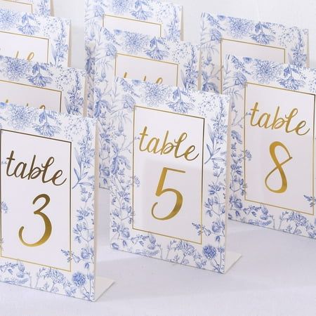 White Blue Paper Wedding Table Numbers Introducing our White Blue Chinoiserie Print Double Sided Paper Wedding Table Numbers, a captivating addition to your special day that effortlessly blends timeless charm and modern elegance. These tent-style table sign cards are meticulously designed to make your reception tables a visual delight. With a stunning chinoiserie floral print and elegant gold foil numbers, these table numbers are a versatile and enchanting choice for any wedding theme. Chinoiserie Floral Double Sided Table Sign Cards Chinoiserie Floral Double Sided Table Sign Cards The chinoiserie floral design evokes the beauty of traditional porcelain, adding a touch of classic elegance to your decor and the bold gold foil numbers from 1 to 25 ensure clear and sophisticated visibility, m Chinoiserie Wedding, Baby Blue Weddings, Blue White Weddings, Wedding Table Number Cards, Light Blue Wedding, Blue Chinoiserie, Paper Table, Blue Themed Wedding, Paper Wedding