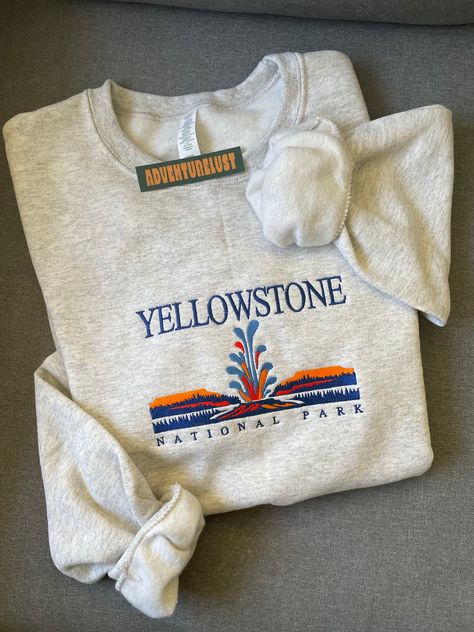 - Yellowstone National Park Embroidered Crewneck - Perfect gift for nature lovers, adventurers, or anyone who loves National Parks.  - Fabrication - Heathered grey color crewneck - 70/20 cotton/poly blend - Size is unisex - Care Instructions - Turn inside out and machine wash cold on delicate cycle - Dry on low heat setting - Do not bleach or dry clean - Processing and Shipping Times - Please allow 3-5 business days for your order to be processed and stitched - Standard shipping takes 3-5 days - State Embroidery, Shirt Outfit Ideas, Wyoming State, Trendy Hoodies, Embroidery Sweatshirt, Vintage Crewneck, Kinds Of Clothes, Cozy Outfit, Fall Sweatshirt