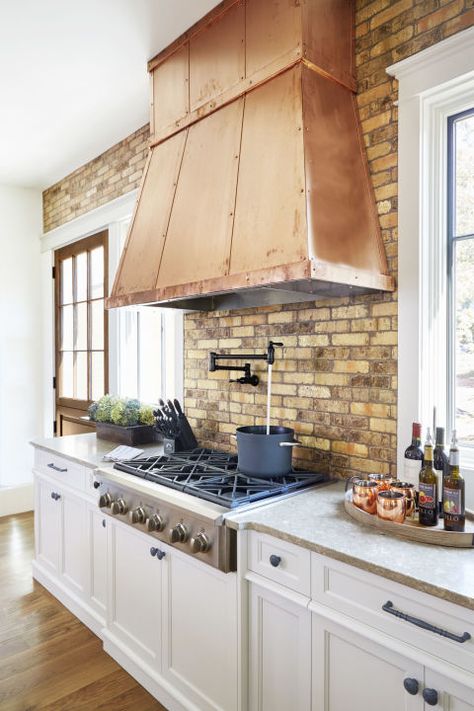 Heavy Up the Metal: The open shelving trend isn't going anywhere and in a kitchen void of upper cabinetry, the hood is inevitably the centerpiece. Dress it accordingly! Copper sheeting, with coordinating straps and rivets, adds age-old warmth. Glass Tiles Kitchen, Glass Tile Backsplash Kitchen, Copper Hood, Chef Kitchen Decor, Kabinet Dapur, Fresh Kitchen, French Country Kitchens, Kitchen Hood, Kitchen Range Hood