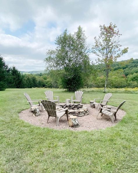 This classic rustic firepit is set in a gravel circle. Adirondack chairs surround the stone firepit with wooden stumps next to them as side tables. Lakeside Fire Pit, Granite Fire Pit, Fire Pit Gravel, Tree Stump Table, Stump Table, Decomposed Granite, Stone Fire Pit, Fire Pit Area, Tree Stump