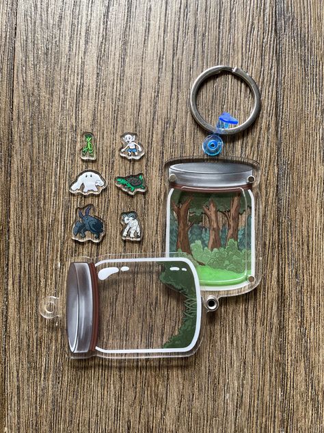 ASSEMBLY REQUIRED.  This shaker charm keychain has 6 acrylic pieces inside (tiny cryptids - Mothman, Grafton Monster, Sheepsquatch, Ouga, Veggieman, and Batboy), which can shake and move.   You can mix and match them as you like.  For the best shake, I recommend only adding 4 at a time.  To remove charms, remove the blue clasp and slide the top acrylic off and change out your cryptids for your journey.  Please peel off the protective plastic before use.  This keychain is double sided, with a sil Monster Energy Can Crafts, Interactive Keychain, Grafton Monster, Acrylic Keychain Design, Shrinky Dink Keychain, Jar Keychain, Make A Keychain, Keychain Bundle, Shaker Charm