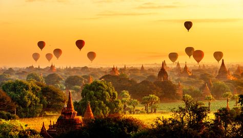 Hot air balloons float above an orange sky as the silhouettes of thousands of temples provide a perfect backdrop. The balloons are used in Bagan, Myanmar, to give tourists take a sky-high view of the beautiful landscape. Bagan Sunrise, Bagan Temples, Bagan Myanmar, Myanmar Travel, Strange Events, Panoramic Photography, Beautiful Landscape Photography, Anime Cover Photo, Weird News