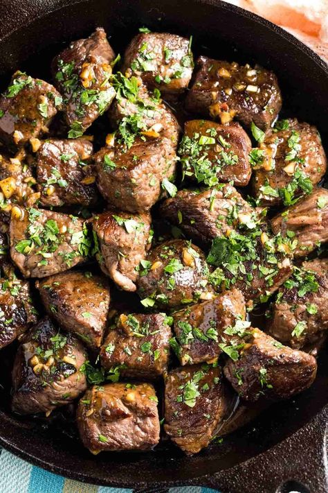 This easy Garlic Butter Steak Bites recipe sears chunks of beef to tender perfection and serves them with a rich bloody mary-inspired red wine sauce for dipping. Ready in less than fifteen minutes, you can enjoy these succulent bites as an appetizer or round them out into a quick dinner. | how to make garlic butter steak bites | garlic butter steak bites recipes | homemade steak bites | steak bites in cast iron skillet | steak bites with garlic butter cast iron | steak bites dinner ideas Steak Bites Recipes, Butter Steak Bites Recipe, Steak Bites With Garlic Butter, Cajun Butter Steak, Beef Rib Steak, Garlic Steak Bites, Boneless Beef Ribs, Easy Garlic Butter, Garlic Butter Steak Bites