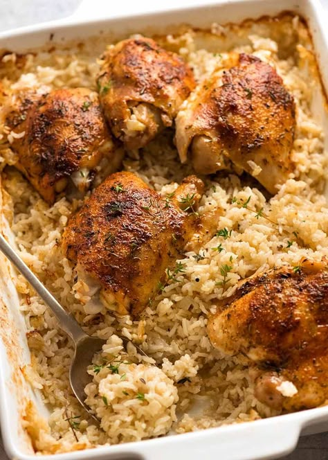 White baking dish with Oven Baked Chicken and Rice, ready to be served Oven Baked Chicken And Rice Recipes, Chicken And Rice Baked In Oven, Oven Baked Chicken And Rice, Baked Chicken And Rice, Garlic Butter Rice, Rice In The Oven, Recipetin Eats, Recipe Tin, Baked Chicken Thighs