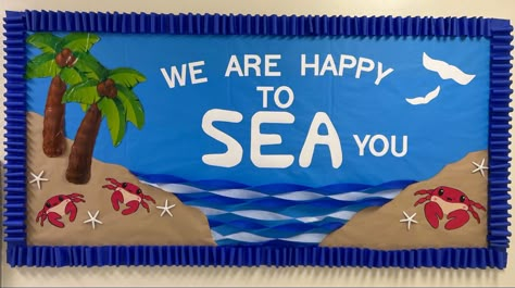 Ocean themed bulletin board with saying ‘We are happy to Sea you’ palm trees, mini crabs and craft paper islands. Welcome Aboard Bulletin Board, Sailing Bulletin Board Ideas, Happy To Sea You Bulletin Board, Aquarium Bulletin Board, Fishing Bulletin Board Ideas, Beach Themed Bulletin Board Ideas, Island Bulletin Board, Ocean Themed Bulletin Boards, Sailing Bulletin Board