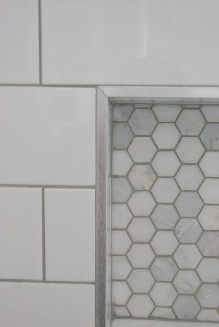 Choosing our shower tile design with subway tile and marble tile niche. This white and gray bathroom features IKEA vanities and herringbone floor. Tile Niche, Tile Shower Niche, Bathroom Niche, Subway Tile Showers, Bathroom Features, Apartment Decoration, Gray Bathroom, Master Shower, Tile Edge