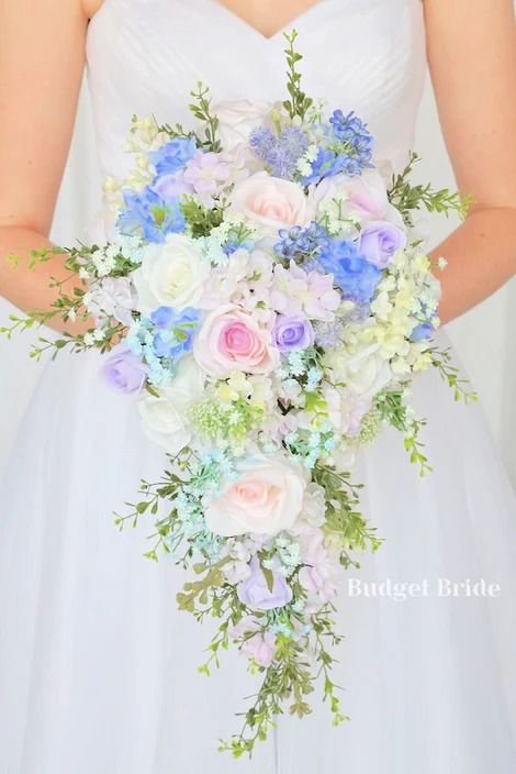 Cheap cascading wedding bouquets made from silk flowers. Customize your bouquet and get matching boutonnieres, corsages, and decor. These cheap wedding flowers are sure to meet your needs, from Budget Bride. Pastel Flower Bouquet Wedding, Wedding Periwinkle, Blue Babies Breath, Periwinkle Blue Wedding, Pastel Garden Wedding, White Lilacs, Pastel Wedding Theme, Roses Lavender, Blush Pink Roses