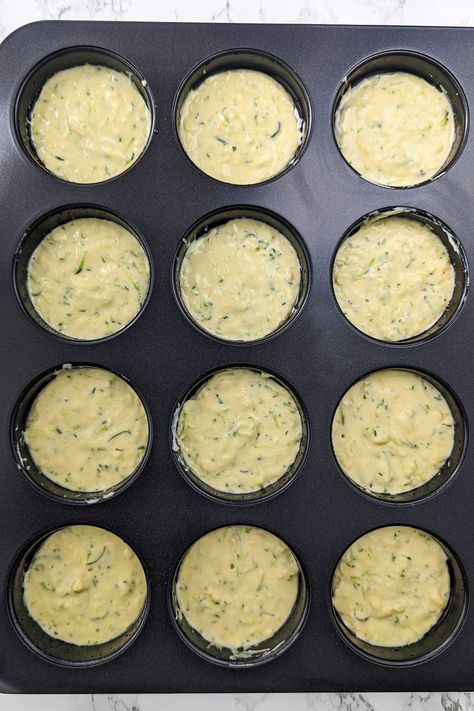 Discover our 4-Ingredient Zucchini Muffins - a healthier, juicier delight made with grated zucchini, self-rising flour, cream cheese, and eggs. Sneak in veggies for the kids and get creative with aromatic herbs. Perfect for breakfast, snacks, or desserts. Impress with this simple recipe, secretly healthy and irresistibly moist. Freeze for on-the-go moments or host charming tea parties. Get ready to fall in love with these tender and heavenly muffins! Zucchini Egg Muffins, Sneak In Veggies, Specialty Breads, Vegetable Muffins, Zucchini Muffin, Zucchini Muffins Healthy, Zucchini Cheese, Zucchini Muffin Recipes, Grated Zucchini