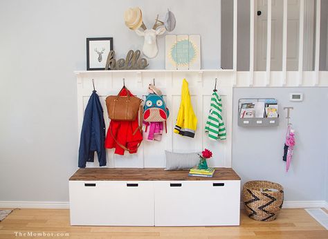 The secret to an organized home is never believing you have enough storage. Here, two storage benches serve an even greater purpose with the addition coat and bag hooks and a ledge shelf up top for adorable art. Get the tutorial at The Mombot » Space Hacks, Ikea Entryway, Ikea Stuva, Ikea Organization, Hacks Ikea, Montessori Room, Diy Mudroom Bench, Mud Room Storage, Coat Closet