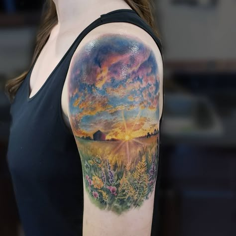 In colour realism, @katarina.heinze was able to capture this piece of Saskatchewan, the "Land of Living Skies," in a tattoo on the arm! There's a lot of detail! The fluffy clouds, the flowers, the sunlight, farm houses and crops! It's such a wonder how artist's can capture light in a picture by using warm colours and using cool colours to contrast. Prairie Tattoo Landscape, Saskatchewan Tattoo Ideas, Color Landscape Tattoo, Western Scenery Tattoo, Field Tattoo Nature, Farm Scene Tattoo, Farm Tattoo Sleeve, Field Of Wildflowers Tattoo, Wildflower Field Tattoo