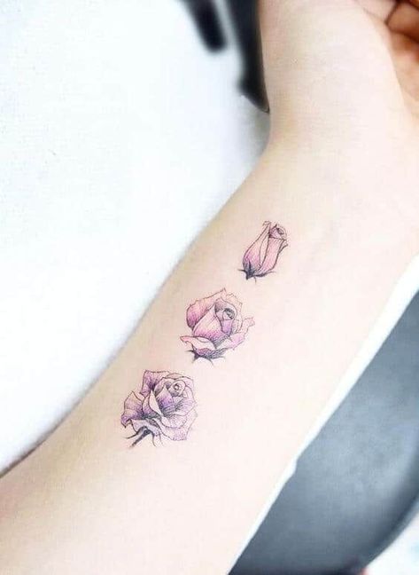 This tattoo has three miniature roses in different blooming stages, the first still closed, the second opening up and the third fully bloomed. Each is designed on the underside of the arm, just below the wrist. The roses also have similar light plum shading. #tattoofriday #tattoos #tattooart #tattoodesign #tattooidea Tato Henna, Rose Tattoos For Women, Roses Tattoo, Disney Tattoo, Wrist Tattoos For Women, Best Tattoo Designs, Design Tattoo, Trendy Tattoos, Tattoo Designs For Women