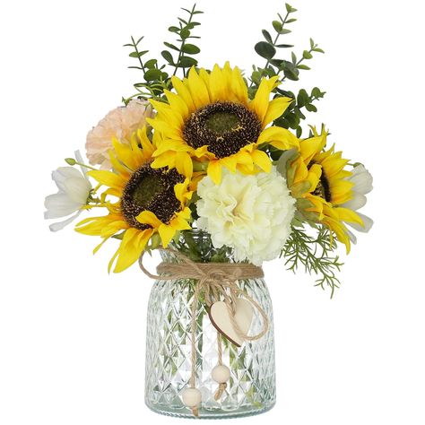 PRICES MAY VARY. LEFTOVER's Faux Flowers in Vase: Artificial silk sunflowers Bouquet in Vase includes 3 sunflowers and 2 carnations(One white and one pink）, as well as some plants and small flowers, and a glass vase with a heart, ball pendant and twine. Perfect for coffee table centerpiece and dining table centerpiece decor Durable and Low Maintenance: Flowers are made of high quality silk, the artificial plants are made of plastic,the stems are lined with wires that can be bent or trimmed, maki Fake Flowers In Vase, Faux Flowers Decor, Vase Table Centerpieces, Faux Flowers In Vase, Sunflowers Bouquet, Flowers With Vase, Transparent Vase, Centerpieces For Tables, Sunflower Centerpieces