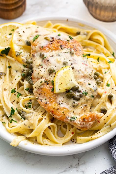 Creamy lemon chicken piccata is a delicious 30-minute meal with lightly breaded chicken breasts smothered in a garlic and caper cream sauce. Creamy Lemon Chicken Piccata, Caper Cream Sauce, Lightly Breaded Chicken, Capers Chicken, Lemon Chicken Piccata, Piccata Recipe, Creamy Lemon Chicken, Breaded Chicken Breast, Chicken Piccata