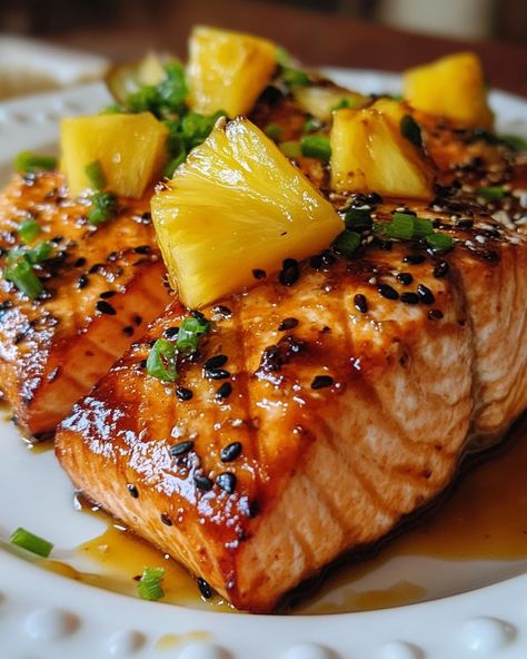 🍍 Easy Honey Pineapple Salmon 🍣 Ingredients - 4 salmon fillets - 1/4 cup (60ml) honey - 1/4 cup (60ml) pineapple juice - 2 tbsp soy sauce - 1 tbsp minced fresh ginger - 2 cloves garlic, minced - 1 tbsp olive oil - Salt and pepper, to taste Instructions 1. Preheat your oven to 400°F (200°C) or heat a grill to medium-high. 2. In a small bowl, whisk together honey, pineapple juice, soy sauce, minced ginger, and garlic. 3. Place the salmon fillets on a baking sheet or grill pan. Bru... Honey Pineapple Salmon, Pineapple Marinade, Pineapple Salmon, Salmon Bites Recipe, Salmon Teriyaki Recipe, Baked Salmon Recipes, Salmon Fillets, Small Bowl, Pineapple Juice