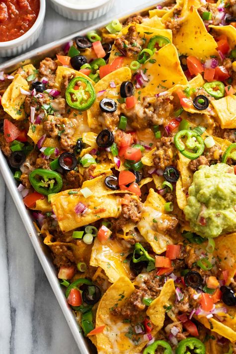 These LOADED Nachos make the BEST party snack and appetizer idea and are SO easy to make with seasoned ground beef and refried beans, melted cheese, and all your favorite toppings! Ultimate Nachos Recipe, Ground Beef Nachos, Loaded Nachos Recipe, Nachos Recipe Beef, Bean Nachos, Beef Quesadillas, Ground Beef Seasoning, Cozy Cook, Seasoned Ground Beef