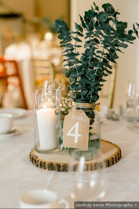 Candle And Mason Jar Centerpieces, 1 Tier Wedding Cake Rustic, Wedding Table Decor With Greenery, Modern Rustic Theme Wedding, Mason Jar Table Numbers, Rustic Wedding Table Decor Mason Jars, Rustic Modern Wedding Centerpieces, Diy Wedding Decorations With Cricut, Wedding Centerpiece Mason Jar