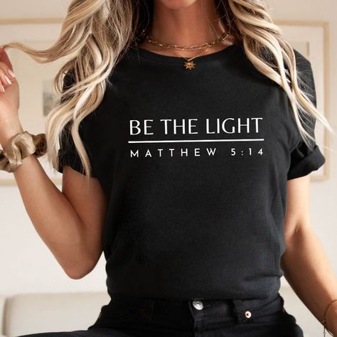 Be The Light Tee - Black / L T shirt #tshirt t-shirt #t_shirt t shirts #tshirts t-shirts #t_shirts T shirt design #tshirtdesign T-shirt designs #t_shirtdesign T shirts designs #tshirtsdesigns 6.84 Christian Tshirts Designs Woman, Christian T Shirt Ideas, Bible Verse T Shirt, Womens Christian Shirts, Christian Tee Shirts, Bible Shirts, Christian Hats, Spiritual Shirts, Church Shirt