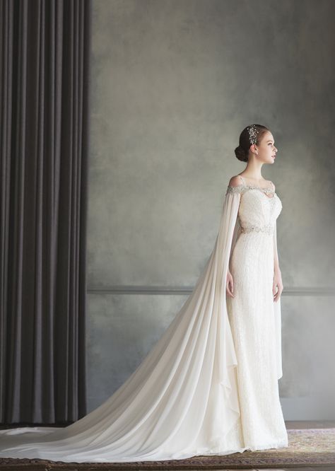 How beautiful is this Bonheur Sposa gown featuring an unique off-the-shoulder jeweled neckline and a stylish cape! Gaun Koktail, Cape Wedding Dress, White Wedding Dress, Trendy Wedding Dresses, A Wedding Dress, Cape Dress, Wedding Dress Inspiration, Dress Robes, Beautiful Wedding Dresses