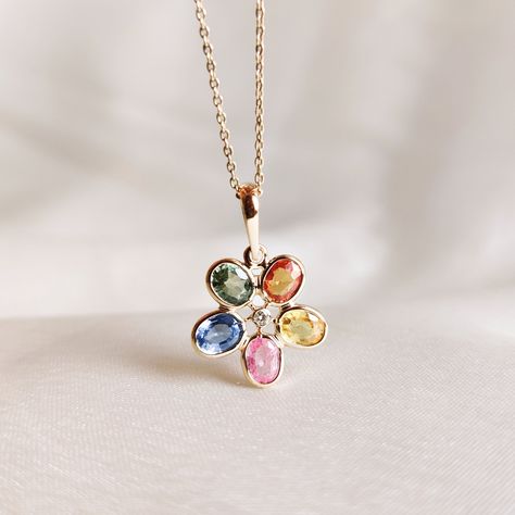 This stunning pendant is set in 14k Solid Yellow Gold with Natural Diamond and Multi Sapphire with utmost precision. It is an unique gemstone necklace for nearly every occasion and is completely hassle-free jewelry. ITEM DETAILS: * Gem: Multi Sapphire * Gem Size: 3x4 mm (5pcs) * Gem Shape: Oval Cut * Gem Weight: 2.14 carats * Gem: Diamond * Gem Size: 1 mm (1pcs) * Gem Shape: Round Cut * Gem Weight: 0.02 carats * Gold Purity: 14KT ~ also available in 18K * Gold Weight: 0.572 gram * Total Weight of the necklace : 1.004 gram The Gold purity is guaranteed and it comes with authentic 14KT gold hallmark. Since my items are handmade, they are absolutely nickel and lead free. CUSTOMIZATION: * The pendant is also available in 14KT/18KT White & Rose Gold. Kindly specify the color you want in the per Elegant Multicolor Jewelry With Flower Pendant, Elegant Multicolor Flower Pendant Jewelry, Yellow Gold Gemstone Necklace In Flower Shape, Multi-stone Oval Pendant Necklace For Gift, Yellow Gold Flower-shaped Gemstone Necklace, Yellow Gold Flower Shaped Gemstone Necklace, Yellow Gold Flower Necklace With Gemstone, 14k Gold Flower Shaped Gemstone Jewelry, Elegant Multicolor Flower Shaped Necklace