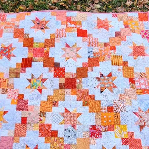 Stephanie | pattern designer & scrap quilter on Instagram: "I realized I never showed off my finished Brightly quilt! I did another low key sew along with some friends and we picked this pattern because it works for scraps and layer cakes. Mine is orange & Low Volume (absolutely inspired by @novaquilts star quilt she made ages ago that I've always loved) Some of the oranges came from Canada, Australia, and Germany!! Thank you to everyone who offered to trade scraps with me 🥰🥰 . Pattern by @cluckclucksew #BrightlyQuilt #SilverSideShugQAL" Brightly Quilt Pattern By Cluck Cluck Sew, Brightly Quilt, Orange Quilts, Cluck Cluck Sew, Heather Bailey, Orange Quilt, Two Color Quilts, Quilting Board, Layer Cakes